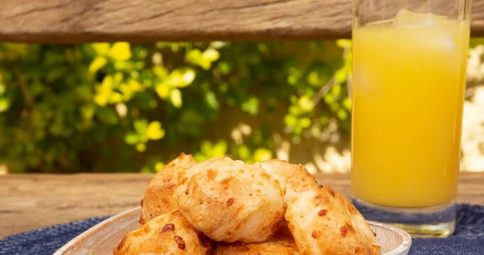 Minas Gerais cheese bread, hot, in a  wooden basket in clean garden background