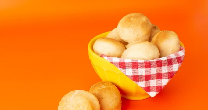 Minas Gerais cheese bread balls in a bowl and clean background front view
