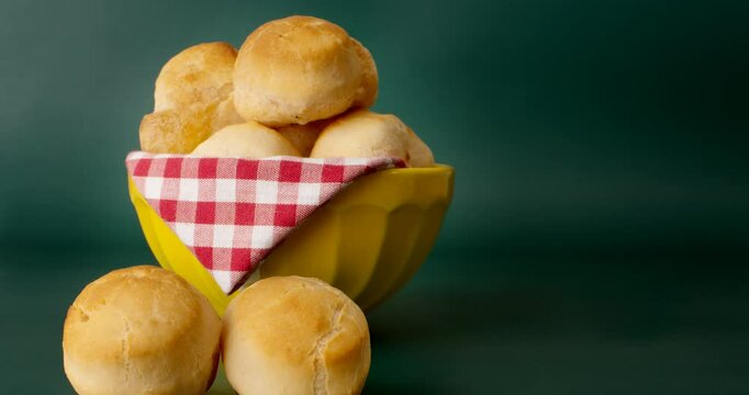 Minas Gerais cheese bread balls in a bowl and clean background front view
