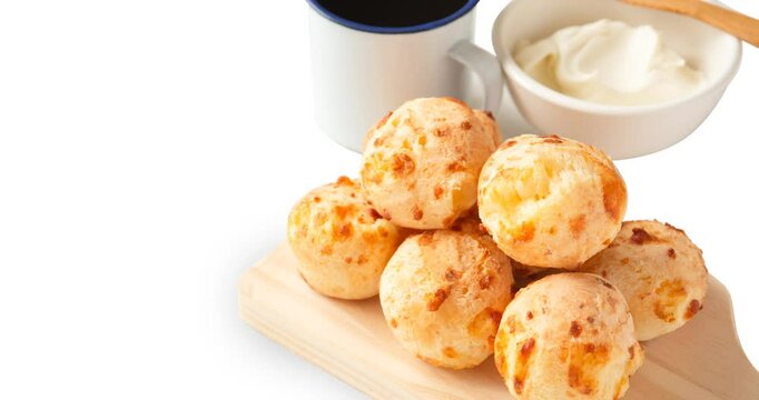 Minas Gerais cheese bread, hot, ina  wooden basket in clean brown background