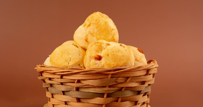 Minas Gerais cheese bread balls in a bowl and clean background front view
