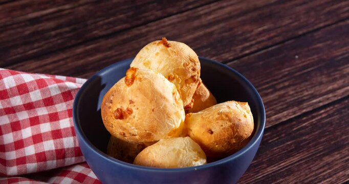 Minas Gerais cheese bread balls in a bowl and clean background front view
