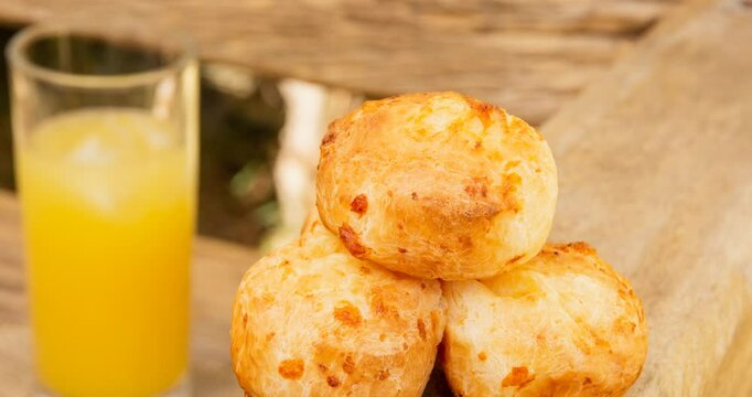 Minas Gerais cheese bread, hot, ina  wooden basket in clean brown background
