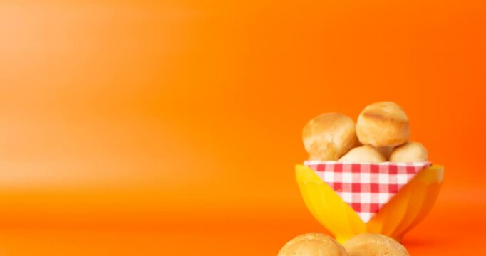 Minas Gerais cheese bread, hot, ina  wooden basket in clean brown background