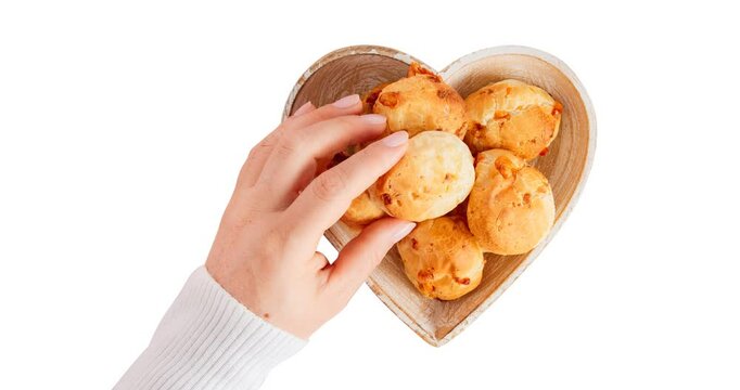 Minas Gerais cheese bread balls in a heart shapped bowl and clean background 
