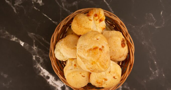 Minas Gerais cheese bread balls in a bowl and clean background front view
