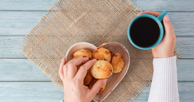 Minas Gerais cheese bread balls in a heart shapped bowl and clean background 
