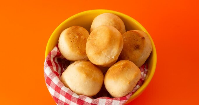 Minas Gerais cheese bread balls in a bowl and clean background front view
