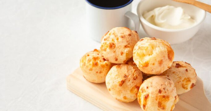Minas Gerais cheese bread balls in a bowl and clean background front view
