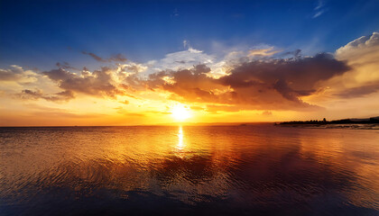 golden sunset reflecting calm waters vibrant clouds