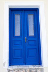 Fototapeta premium The blue-coloured door of a historic house.