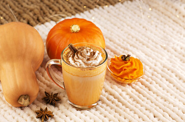 Pumpkin spice latte with whipped cream and ingredients.