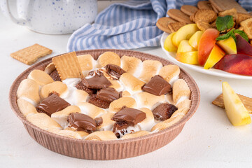 Air fryer s'mores dip with graham crackers, cookies and fruit, trendy homemade version of camping treat s'mores