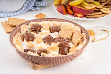 Air fryer s'mores dip with graham crackers, cookies and fruit, trendy homemade version of camping...