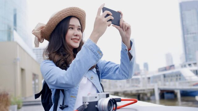 Young Asian female tourists are happy to travel during their long weekend holiday. Traveling around the city by public transportation