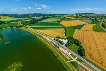 Ausblick auf die Härtsfeldbahn mit ankommendem Dampfzug am Haltepunkt Katzenstein nahe Neresheim