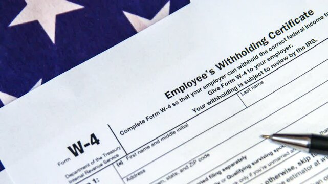 Employee's Withholding Certificate W4 footage with USA flag, 4k.W-4 form on American flag.