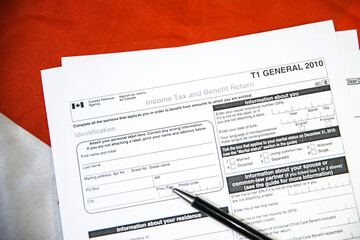 Income Tax and Benefit Return T1 form for Canada, tax filling information concept background with pen on the paper