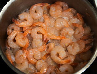 Shrimp boil in pan at home. Selective focus with shallow depth of field.