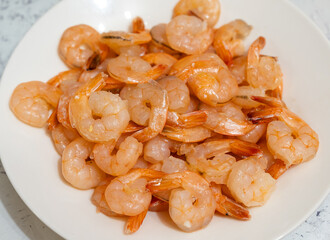 Cooked shrimps on white plate. Selective focus with shallow depth of field.