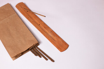 Aroma sticks with a wooden stand on a white background