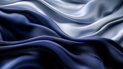 Abstract silk fabric in gradient tones of midnight blue and soft silver, with soft flowing waves creating an elegant, serene background.