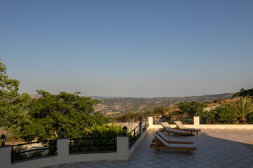 Sun loungers overlooking Cypriot hills and mountains