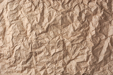 crumpled brown paper surface, brownish tone wrinkled sheet of paper background or backdrop texture, copy space for text