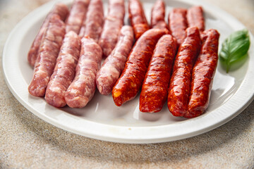 sausages meat raw beef, pork, chicken, lamb dish fresh delicious gourmet food background on the table rustic food top view copy space