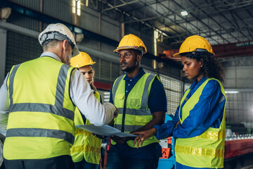 The Manager are taking a safety briefing before work. Implementation of safety culture at Factory. Factory Meeting:  Chief Engineer Talking to Colleagues Before Work Day in Heavy Industry
