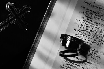 Bible text page close up with objects black and white