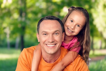 Naklejka premium Joyful dad with little smiling daughter have fun