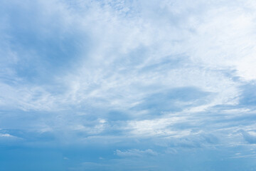 Fluffy white clouds drift across a vibrant blue sky, creating a breathtaking natural masterpiece