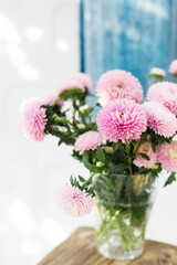 bouquet of asters on the table in the summer garden