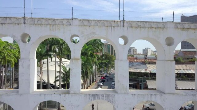 Aerial view of the historic arches of Lapa, Rio de Janeiro, surrounded by urban landscape and greenery.