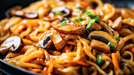 Fototapeta premium Close-up of delicious stir-fried noodles with mushrooms, carrots, and green onions, showcasing a rich and savory sauce glistening over the ingredients.