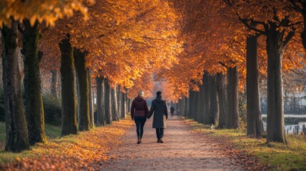 Couple Walking Hand-in-Hand Through a Pathway Lined with Autumn Trees