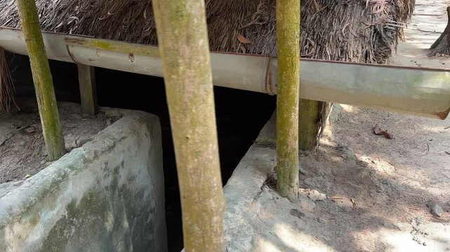 dungeon entrance tunnel camouflaged Cu Chi tunnels were the Viet Cong's base of operations for the Tet Offensive in 1968. Famous tourist attraction in Vietnam