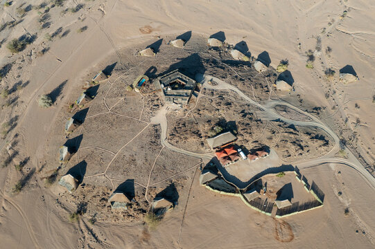 Aerial view of The Doro Nawas Camp and arid desert plains at the edge of the dry bed of the Aba-Huab river, at dawn, Damaraland, Kunene Region, Namibia.