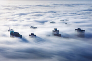 View of Cape Town city skyline in foggy morning with skyscrapers, Signal Hill, South Africa.