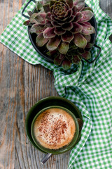 Cappuccino coffee on a wooden table, top view.