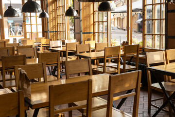 A tranquil cafe with wooden chairs and large windows in a quiet neighborhood