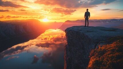 A silhouetted figure stands on the edge of a cliff at sunset, reflecting serenity and adventure in a breathtaking landscape.