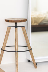 Stylish wooden chair in the interior of the room. Interior and style concept.