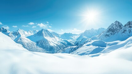 Panoramic view of snow-covered mountains with a clear blue sky and bright winter sunshine.