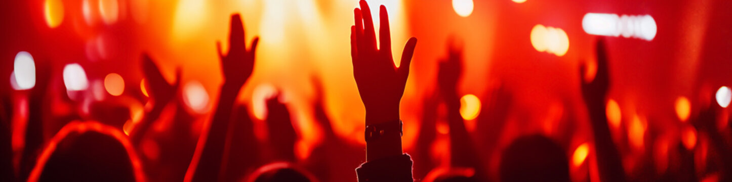 Worshippers raising hands during a vibrant Christian music concert in an energetic atmosphere