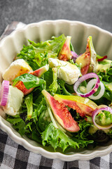fig salad green lettuce, figs, soft cheese fresh meal food snack on the table copy space food background rustic top view keto or paleo diet vegetarian vegan food