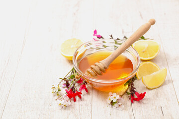 Bowl of Honey with Spoon and Flowers &ndash; Organic and Natural Sweetness