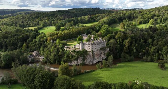 Fairy tale medieval castle in a green hill landscape.