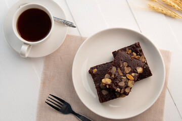 fudge almond brownies.Chocolate Brownie with Almond Sliced Topping in white plate.Top view.